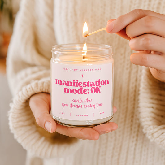Manifestation Mode ON faith candle with pink label and pink text, hand poured coconut apricot wax candle in amber glass jar