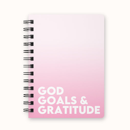 Ombre pink spiral notebook with 'God Goals & Gratitude' text on front cover, goal planning journal
