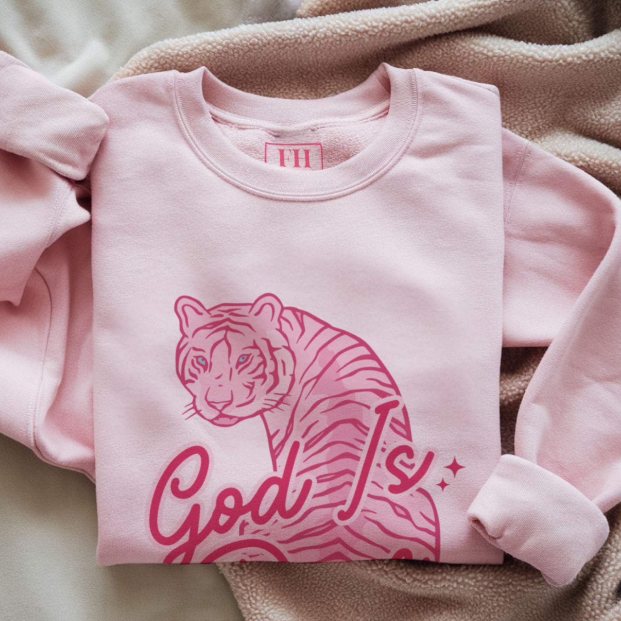 Close up of God Is Dope retro script text with pink tiger illustration, trendy Christian streetwear sweatshirt design