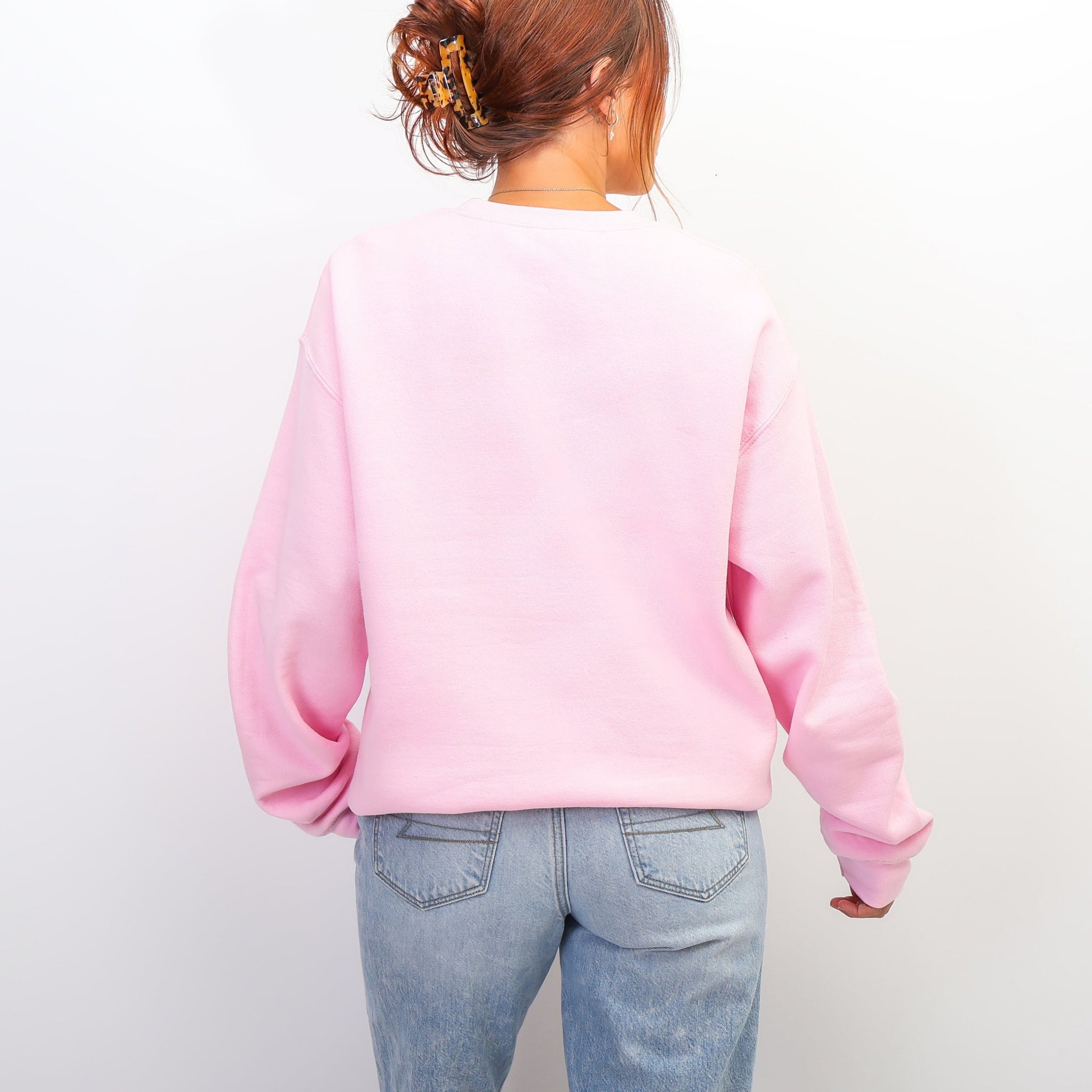 Back view of pink Be The Reason Someone Believes In Good People sweatshirt - oversized inspirational crewneck for women