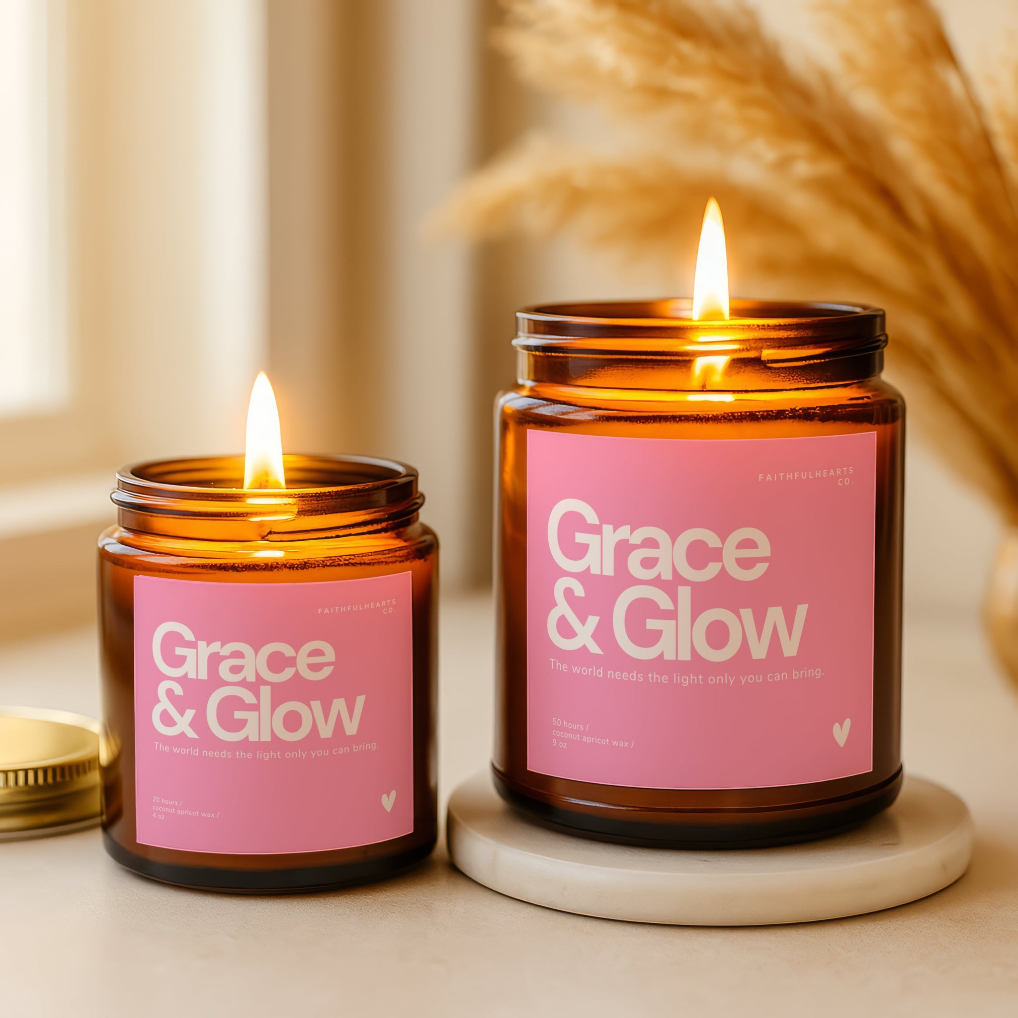 Grace & Glow inspirational candle in amber glass jar with soft pink label, uplifting gift for spiritual women, featuring quote “The world needs the light only you can bring.”