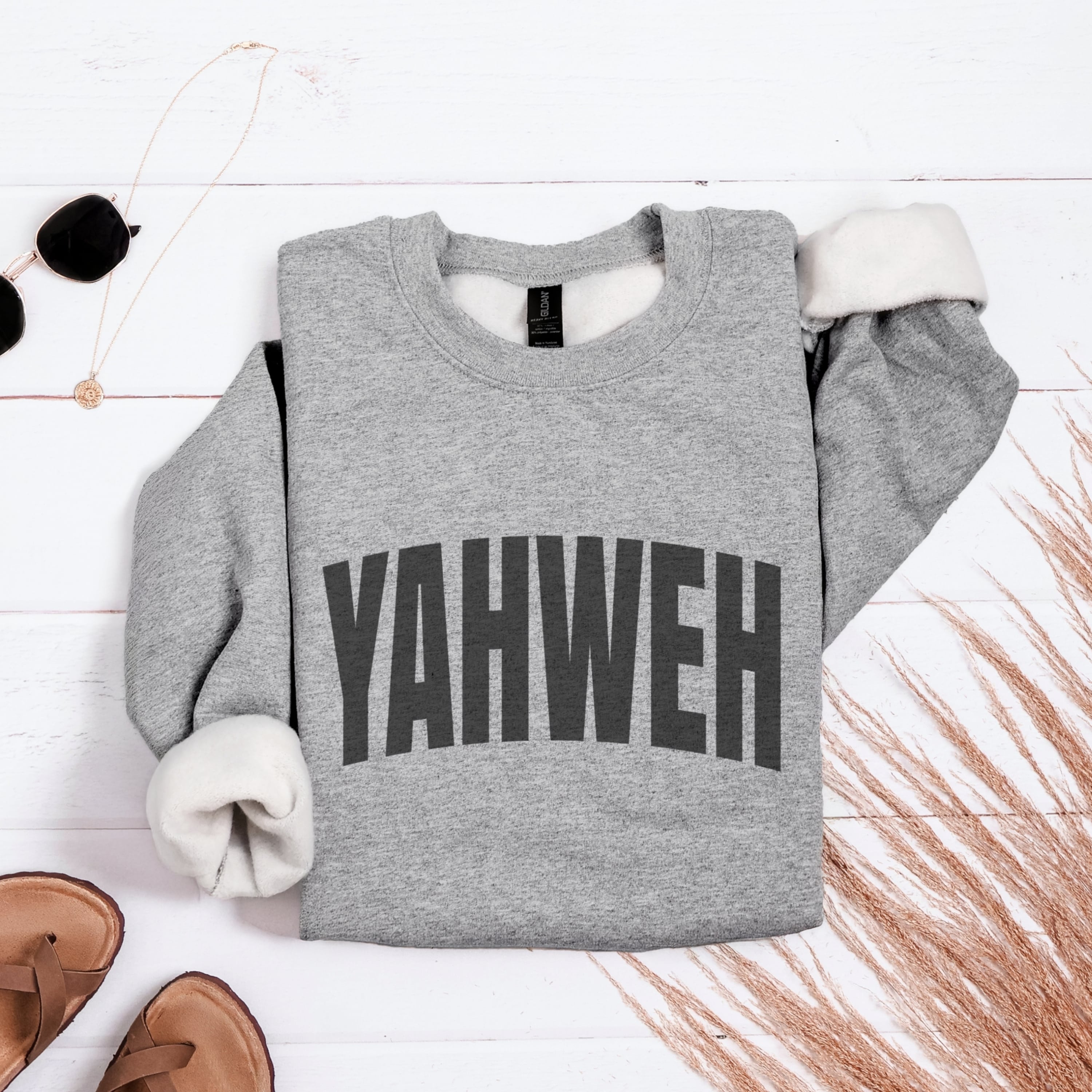 Grey YAHWEH sweatshirt flat lay showing bold typography - oversized Christian Hebrew God name apparel