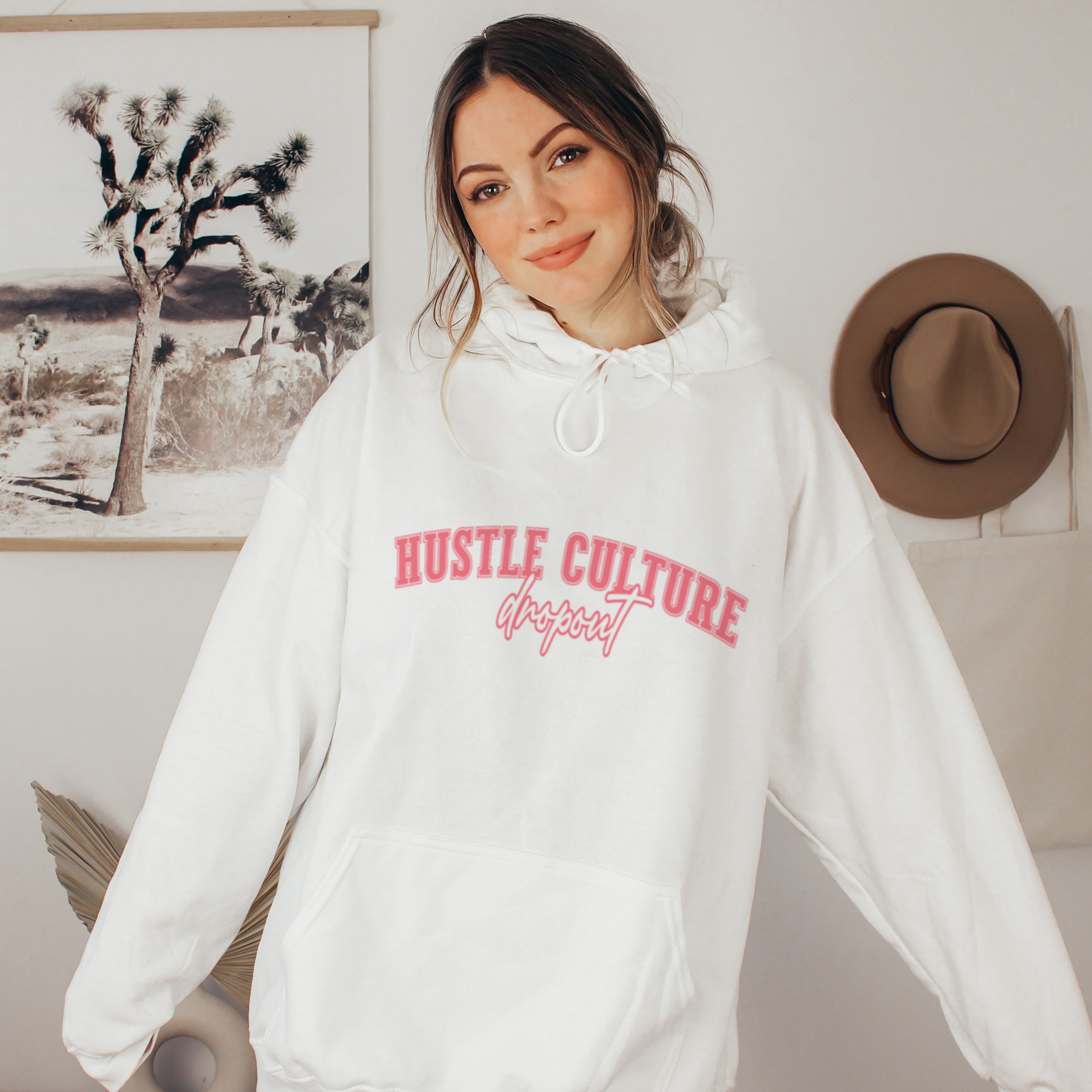Woman in white hustle culture dropout hoodie, cozy anti-grind soft life sweatshirt