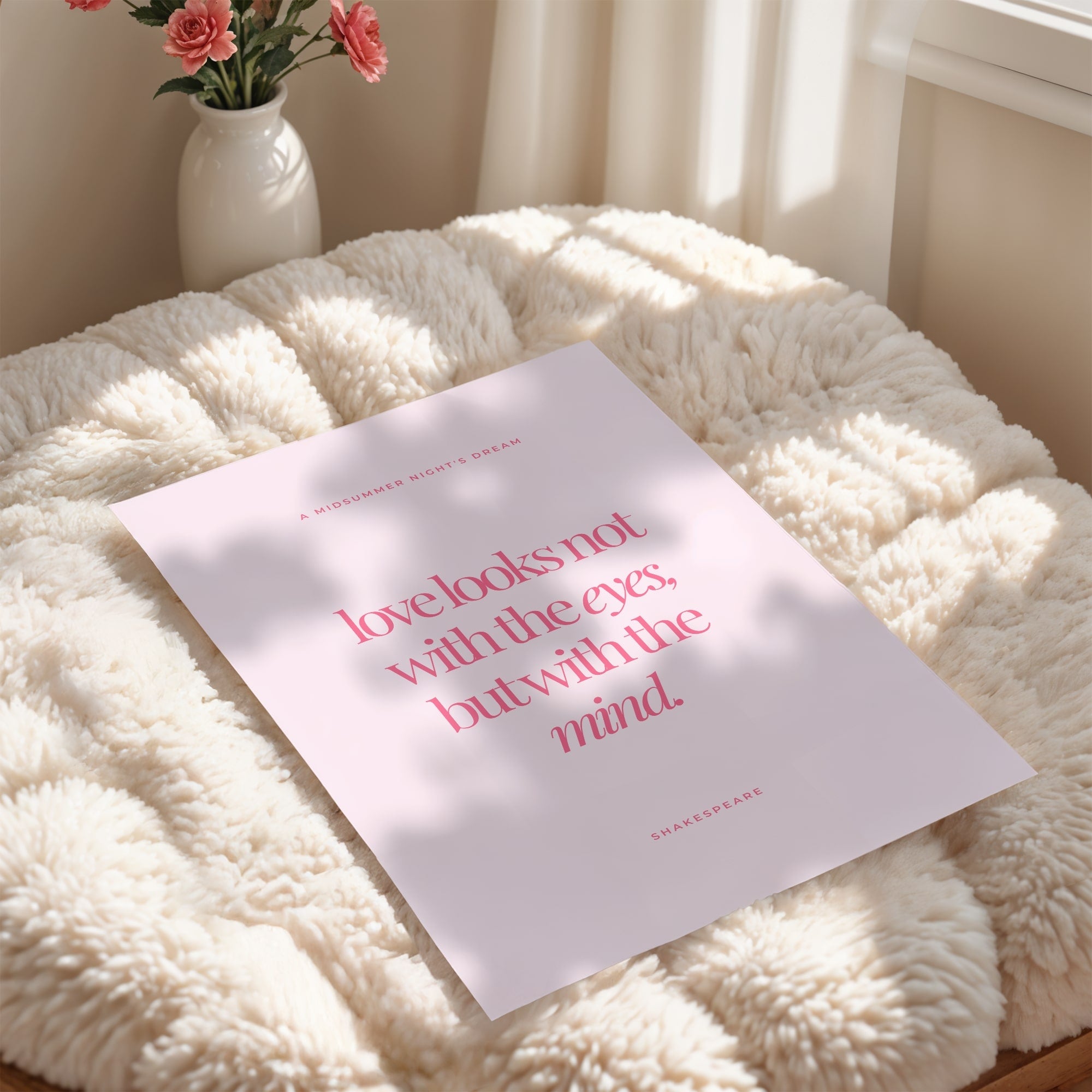 Shakespeare quote wall art print reading 'love looks not with the eyes, but with the mind' in coral pink serif typography on soft blush pink background, romantic feminine literary decor from A Midsummer Night's Dream