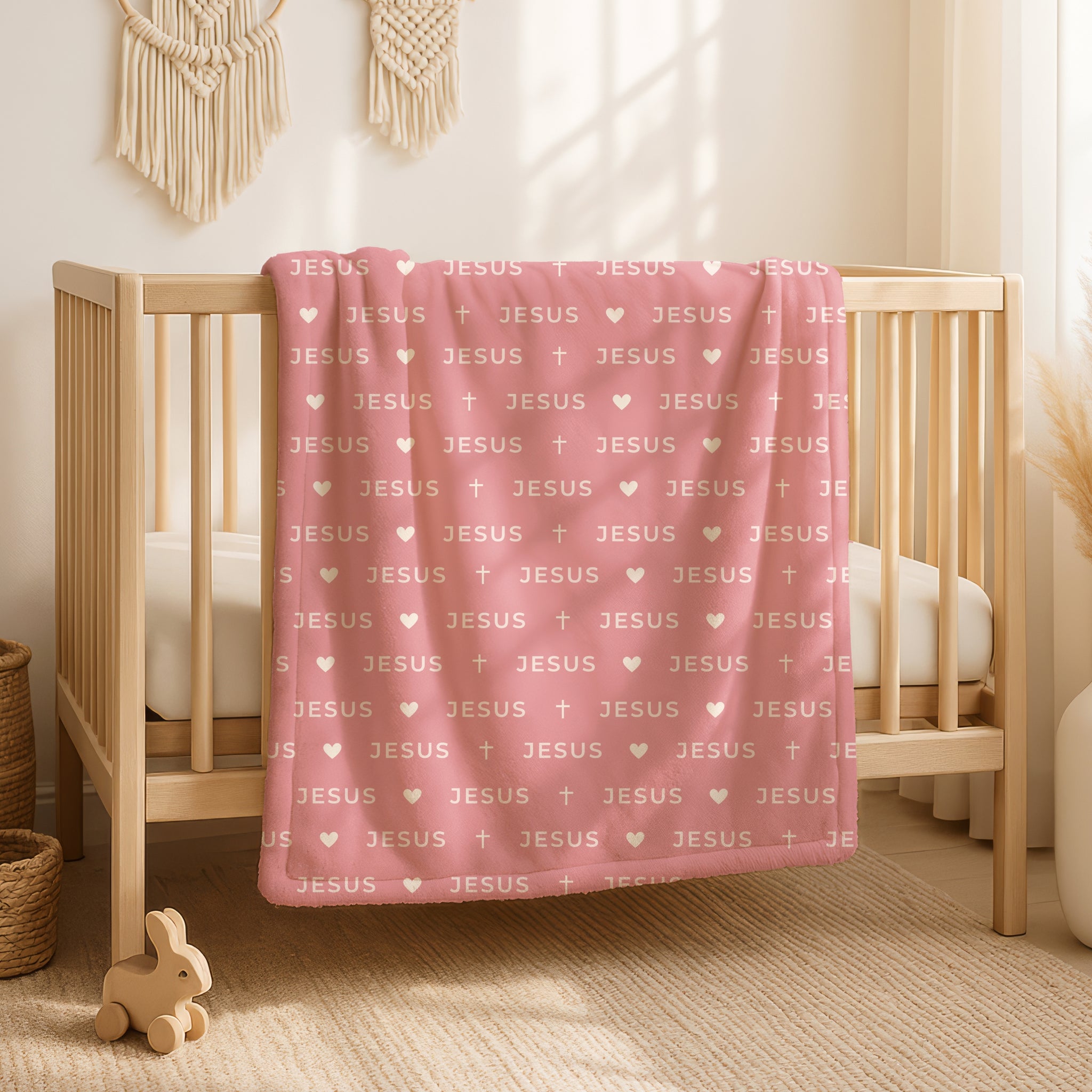 Blush pink blanket with cream JESUS lettering in minimalist modern design