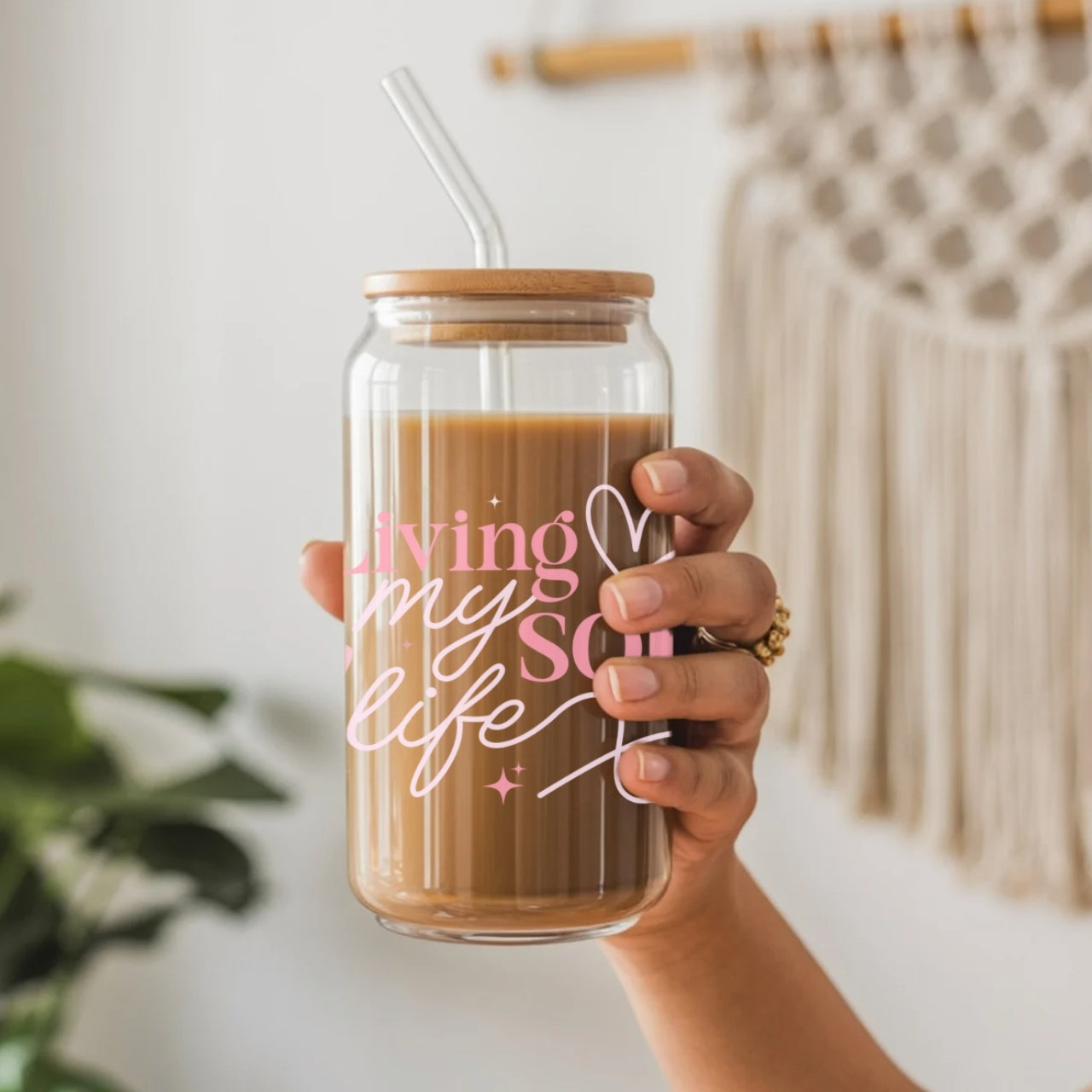 Woman holding clear glass tumbler with 