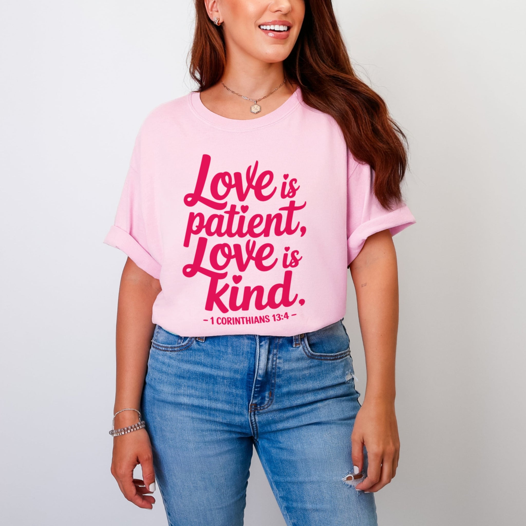 Woman wearing light pink Love Is Patient Love Is Kind tshirt with 1 Corinthians 13:4, pink colored faith scripture tee