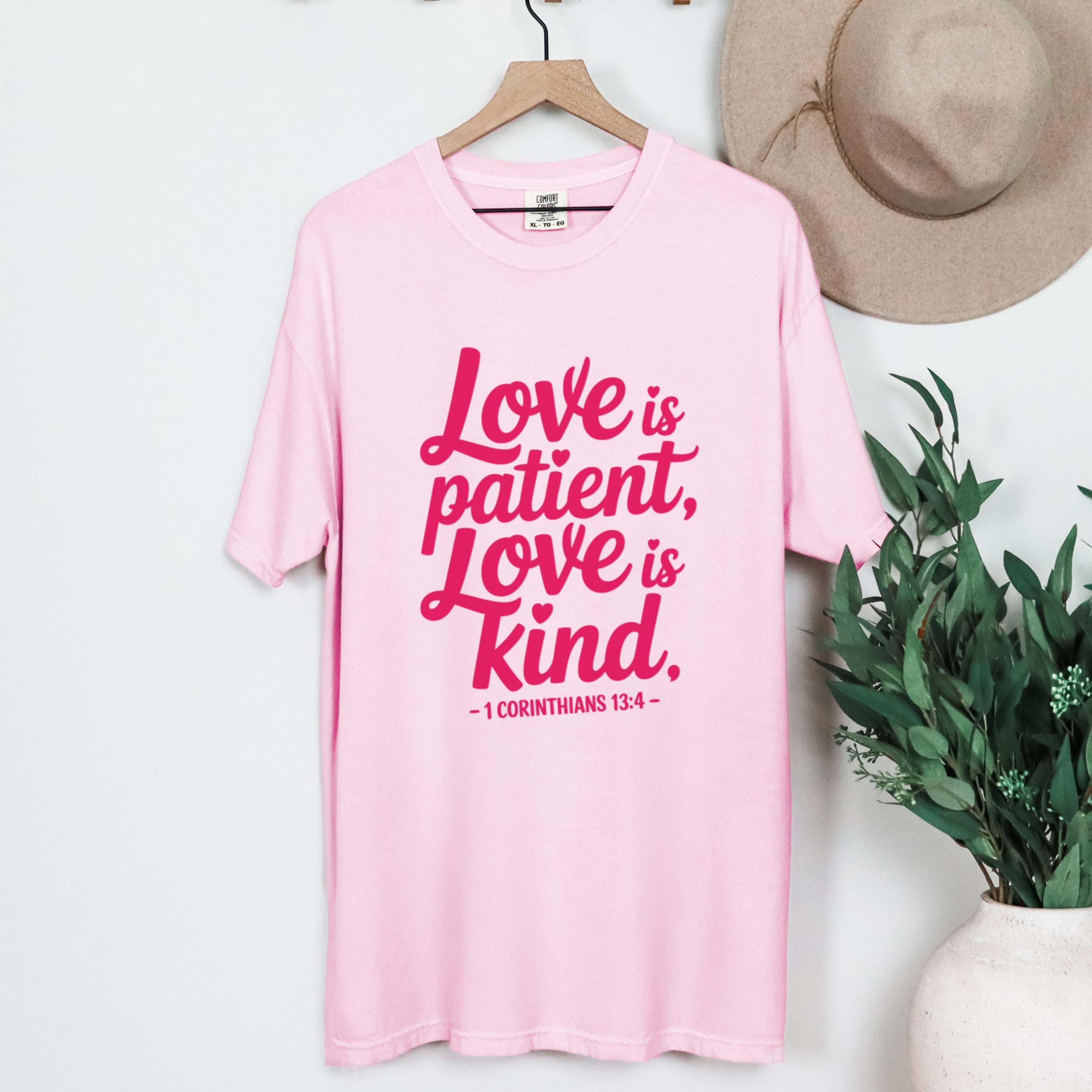 Oversized fit 1 Corinthians 13:4 tshirt in blossom pink styled with jeans, faith-based graphic tee for women