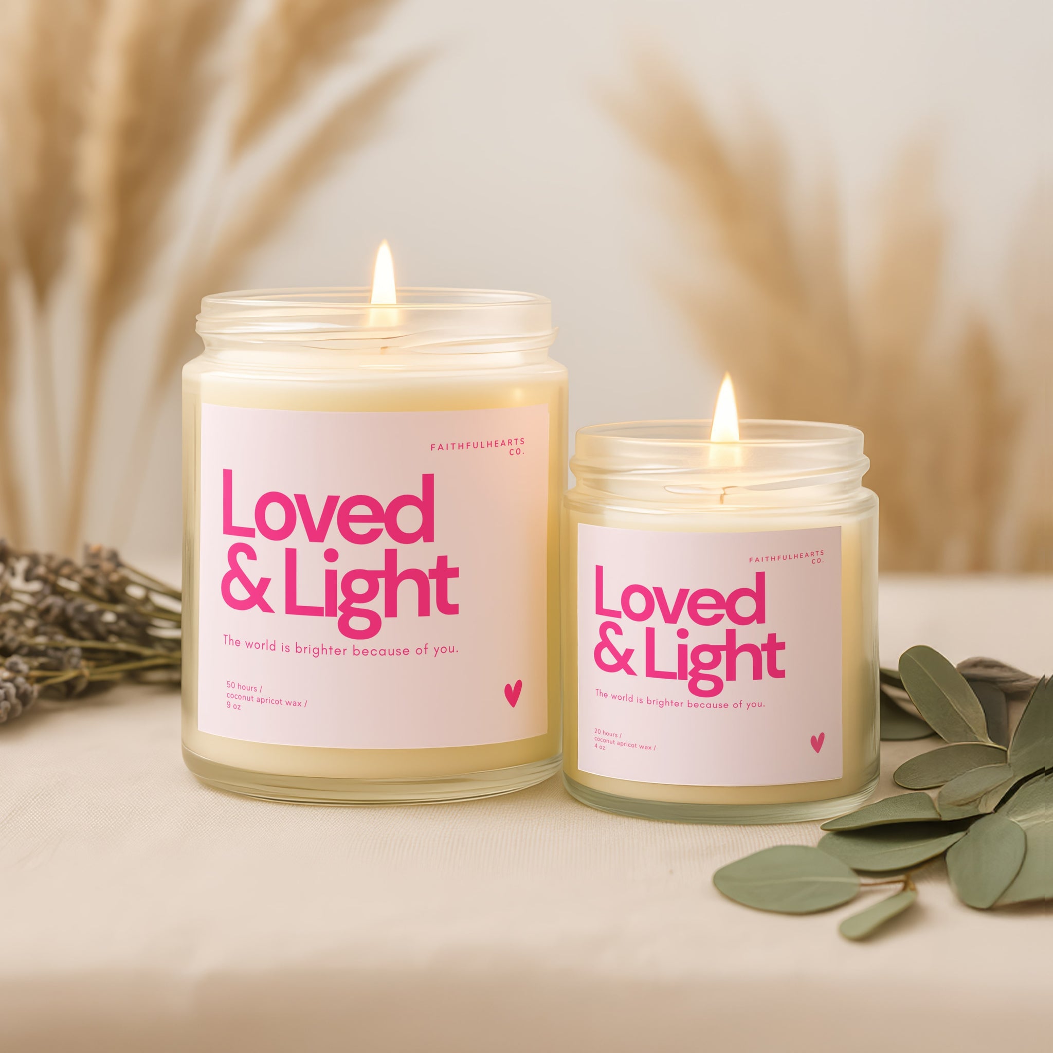 Clear glass Loved & Light candle with soft pink label, handcrafted coconut apricot wax candle for women embracing gentle, soft life energy.