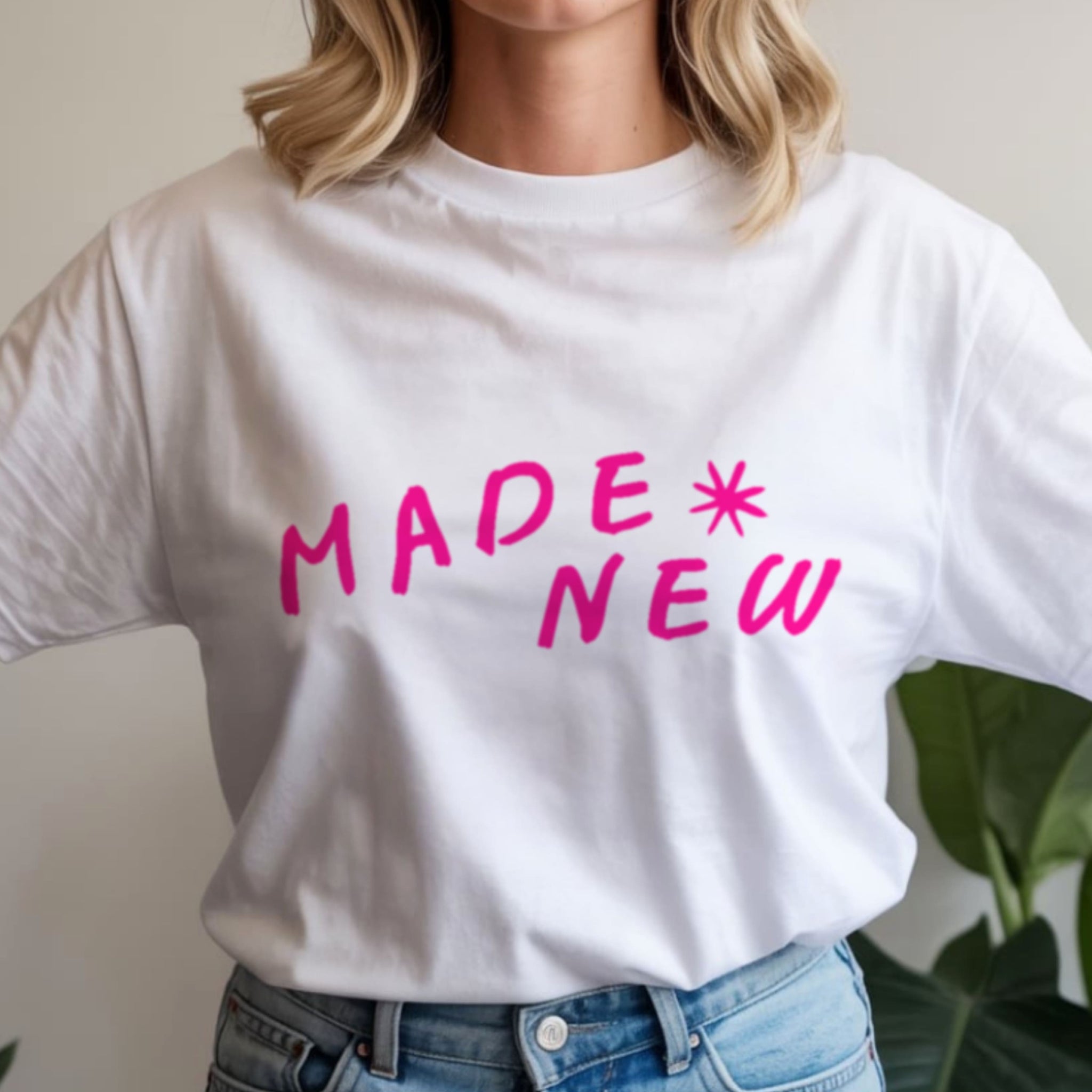 Woman wearing Made New white Christian t-shirt styled with jeans, casual faith-based fashion outfit for women