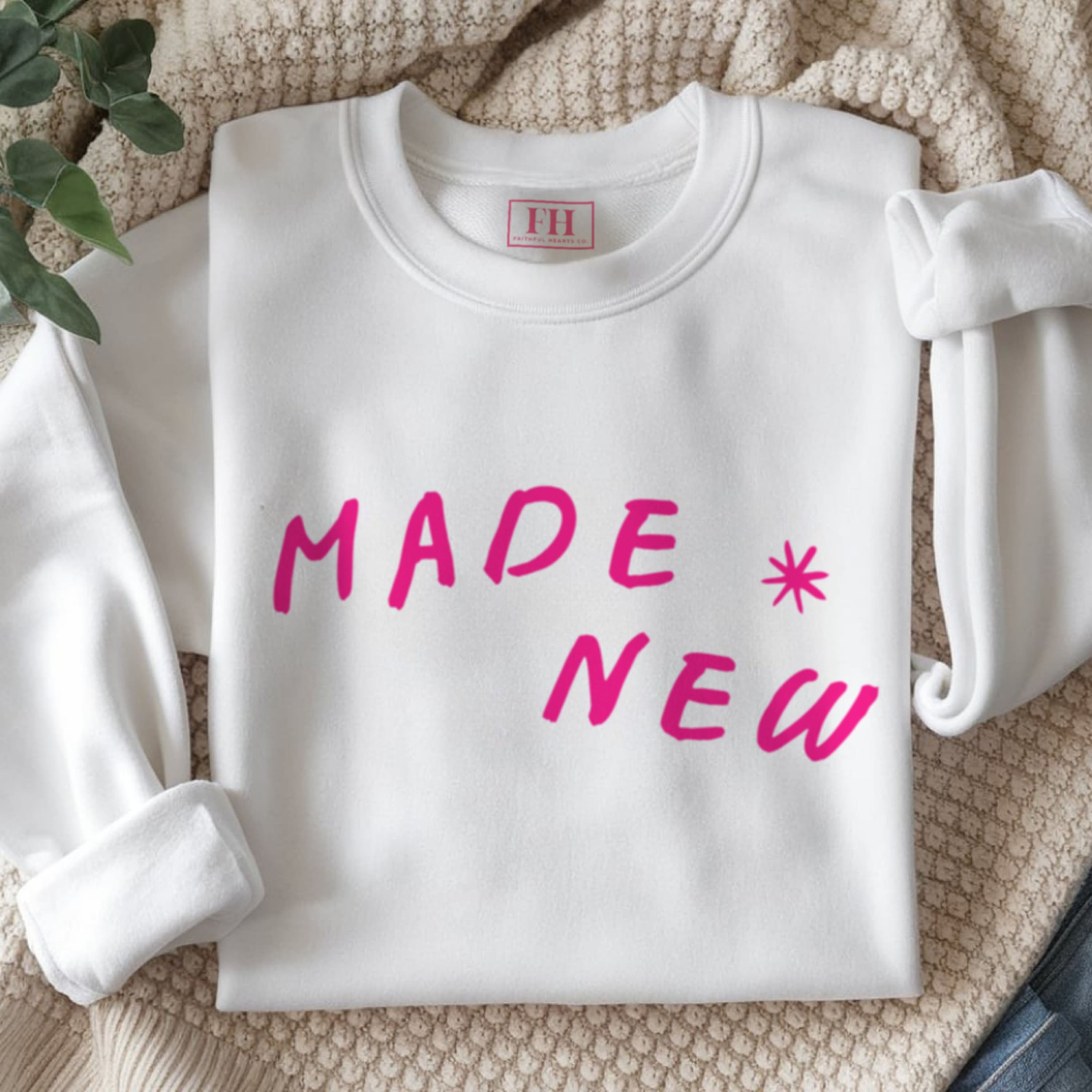 Close up of hot pink Made New text on premium cotton-polyester blend faith sweatshirt with ribbed collar