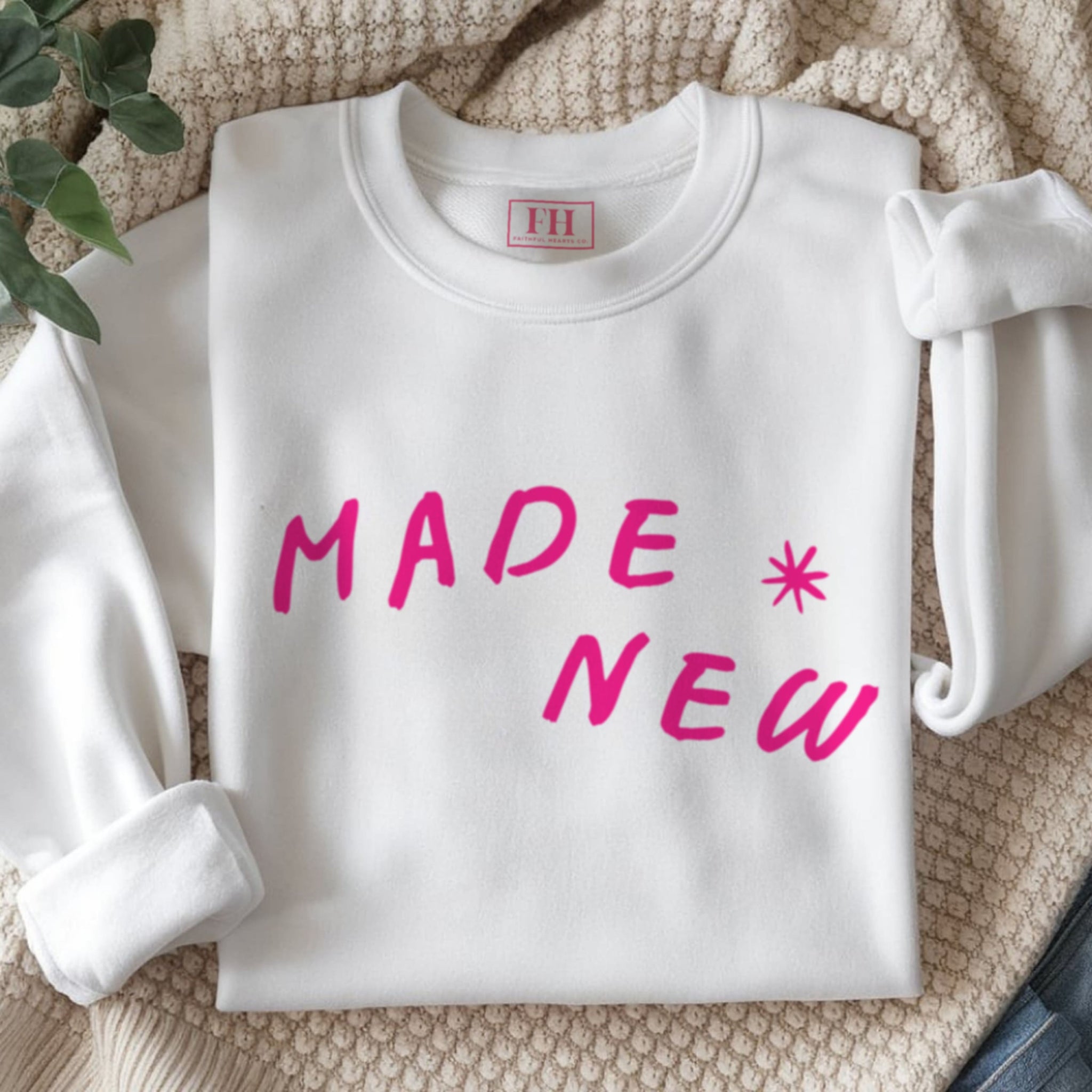 Close up of hot pink Made New text on premium cotton-polyester blend faith sweatshirt with ribbed collar