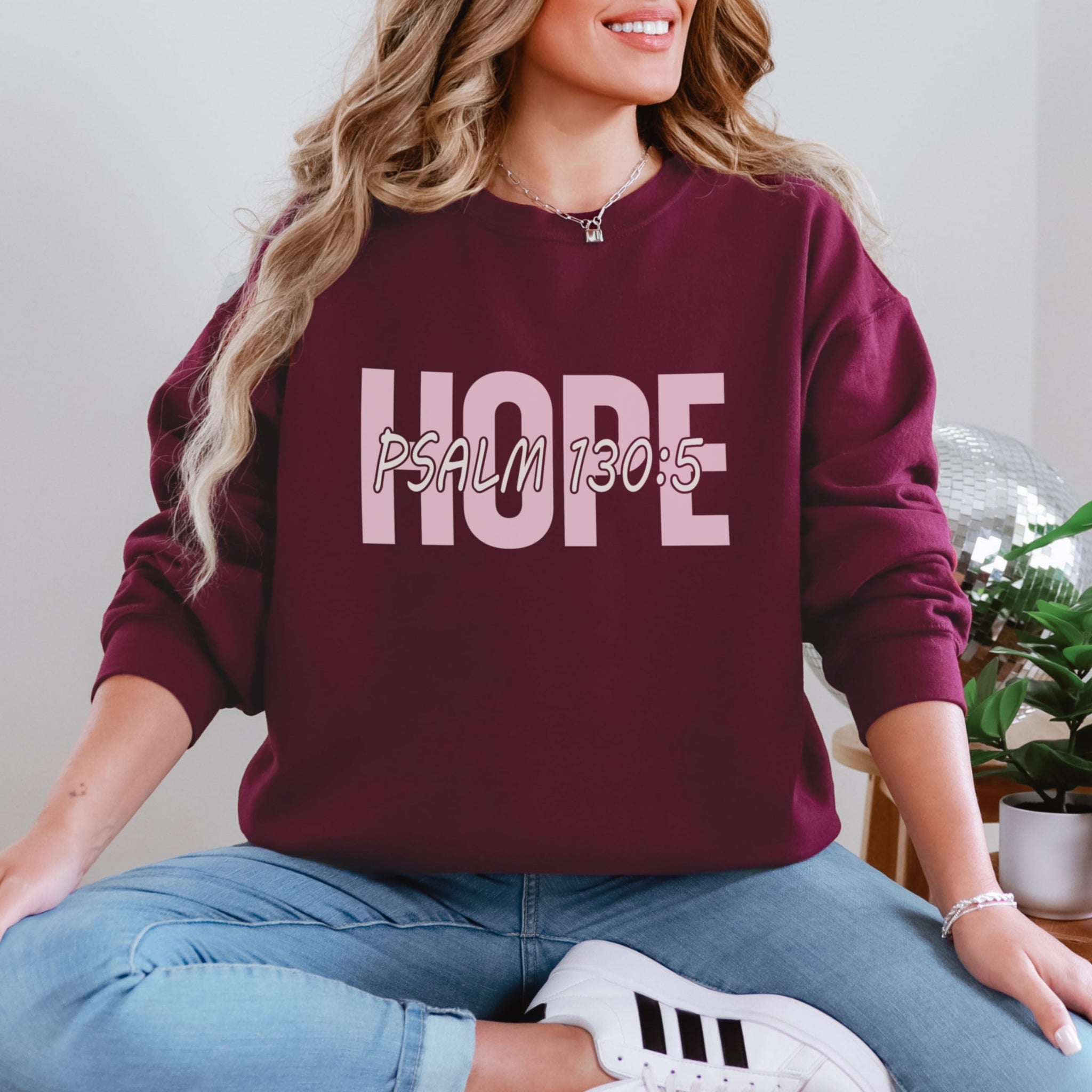 Woman wearing maroon Hope sweatshirt with Psalm 130:5 scripture