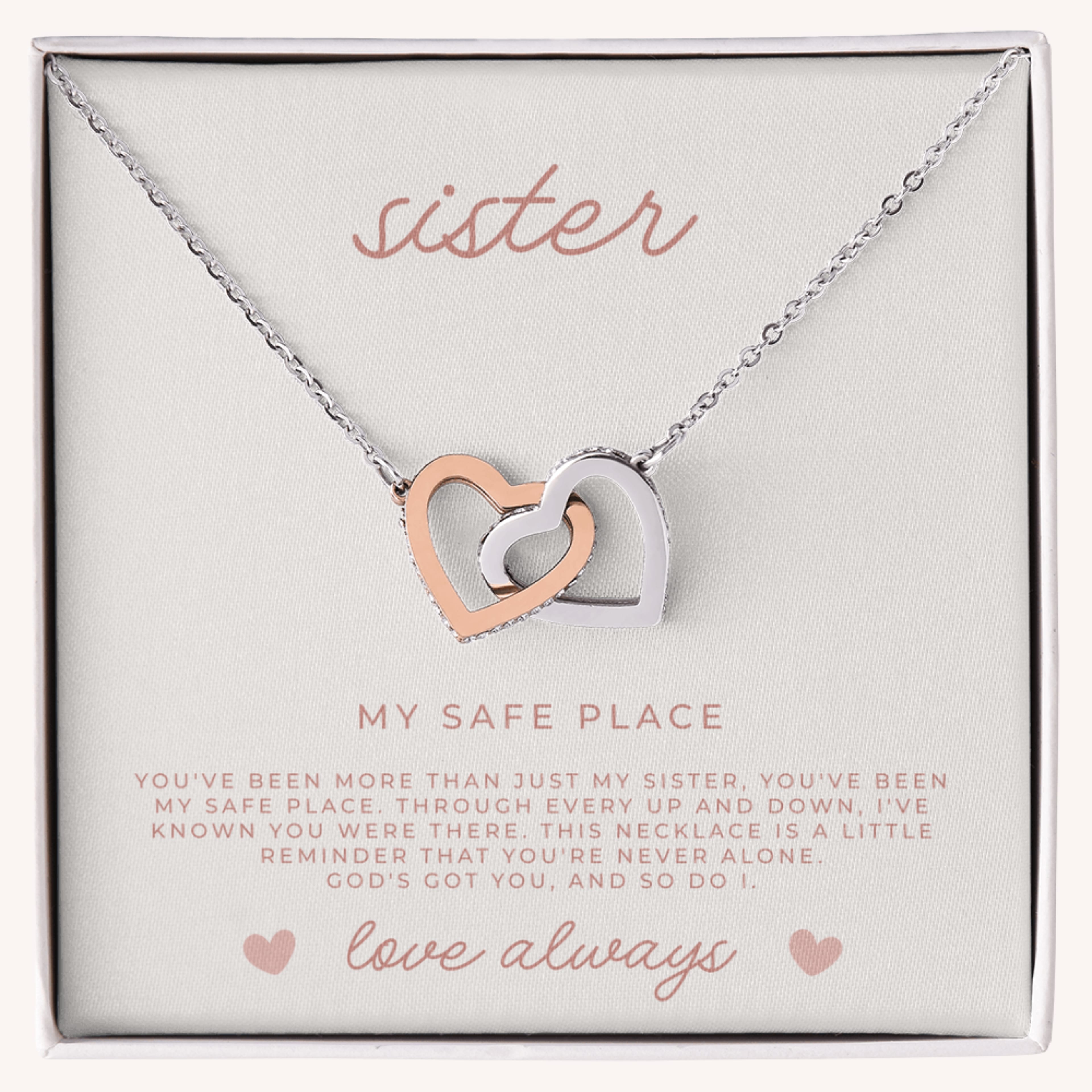 Silver and rose gold waterproof necklace with interlocking heart pendants on a card that reads 'sister, my safe place' and a faith filled message.