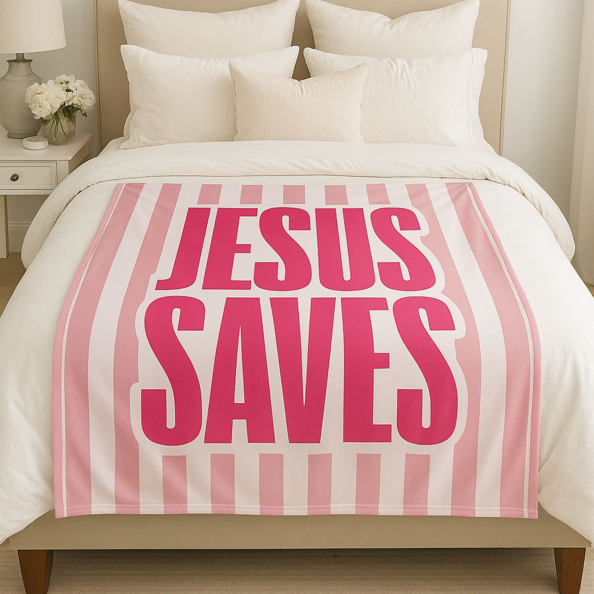 Feminine bedroom with cozy bed styled with a pink and white Jesus Saves Christian blanket