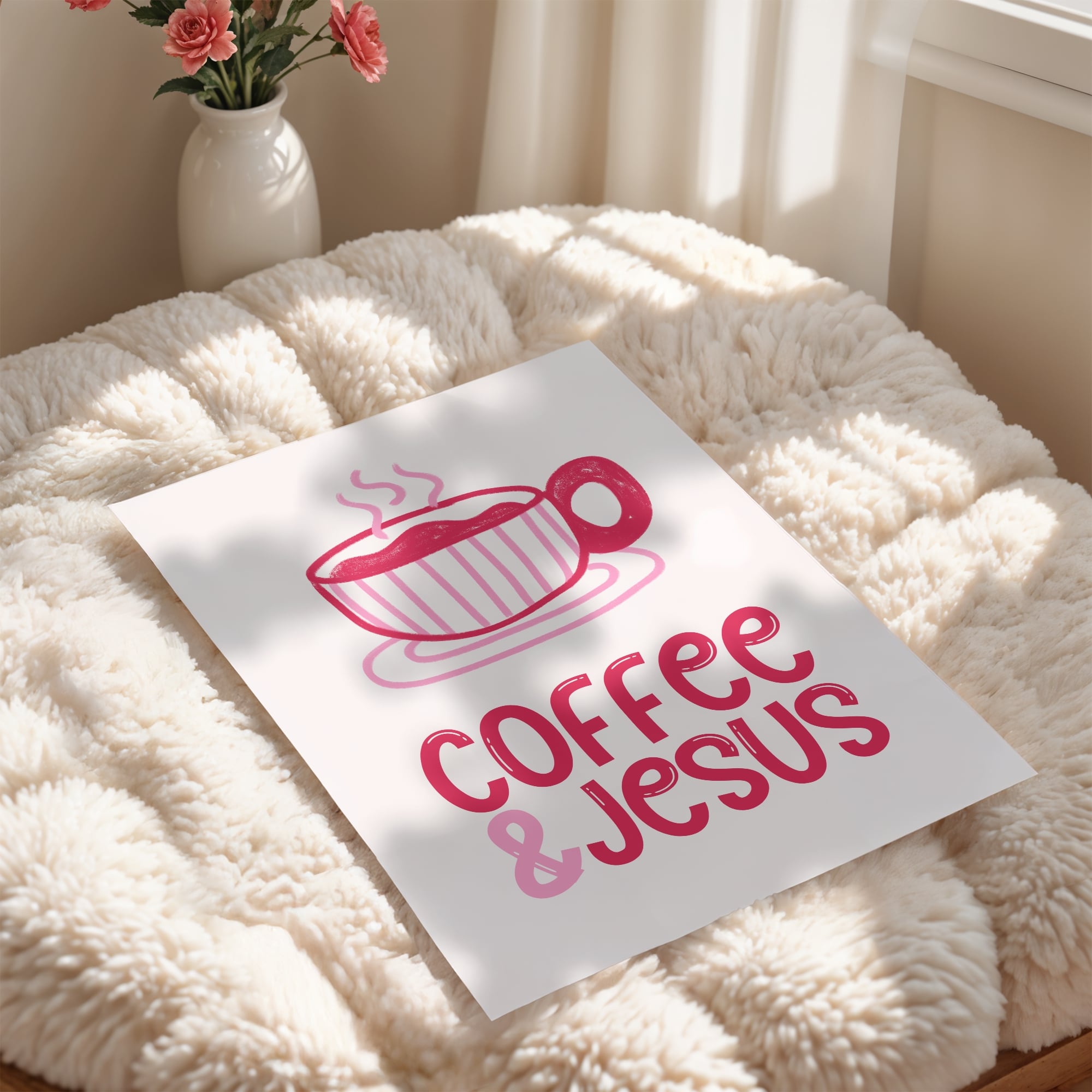 Poster with 'Coffee & Jesus' design on a fluffy surface with a vase of flowers in the background.