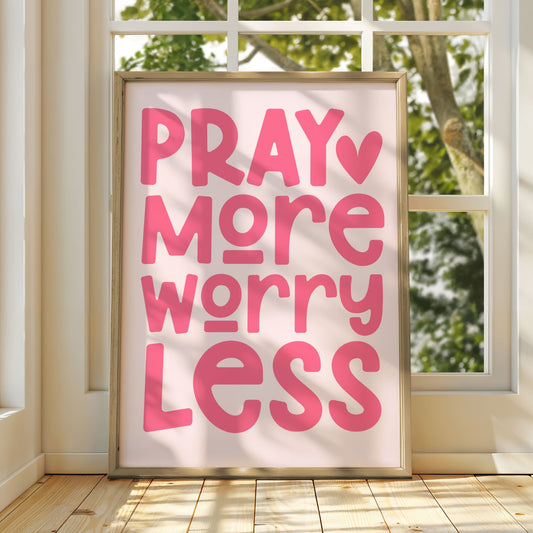 Pray More Worry Less Christian wall art print with soft blush pink background and coral pink bold typography with heart accent, peaceful faith-based home decor