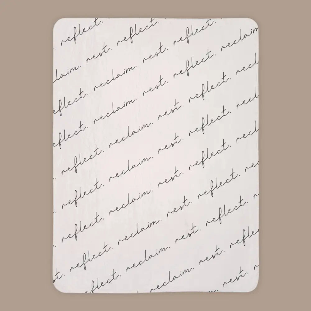cream colored luxury sherpa blanket from Faithful Hearts with reflect reclaim rest written in script font across the front