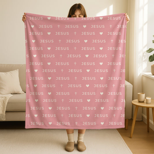 Jesus name blanket in soft dusty rose pink mauve color with repeating Jesus text pattern, small hearts and crosses in cream white, double-sided minimalist Christian throw blanket