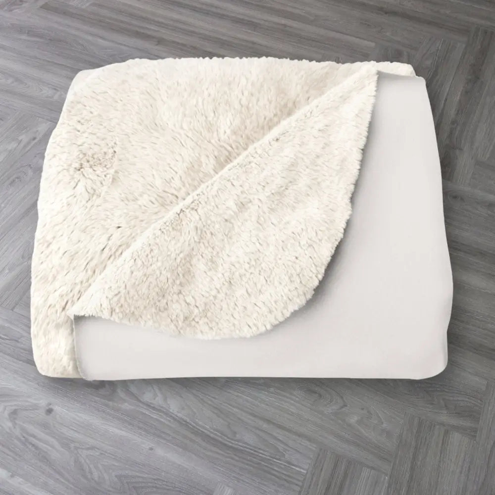 luxury sherpa fleece blanket from Faithful Hearts in cream with the word soft on the front folded on the floor
