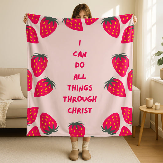 I can do all things through Christ blanket in soft blush pink with cute strawberry border design, Philippians 4:13 scripture in bright pink text, double-sided Christian throw blanket