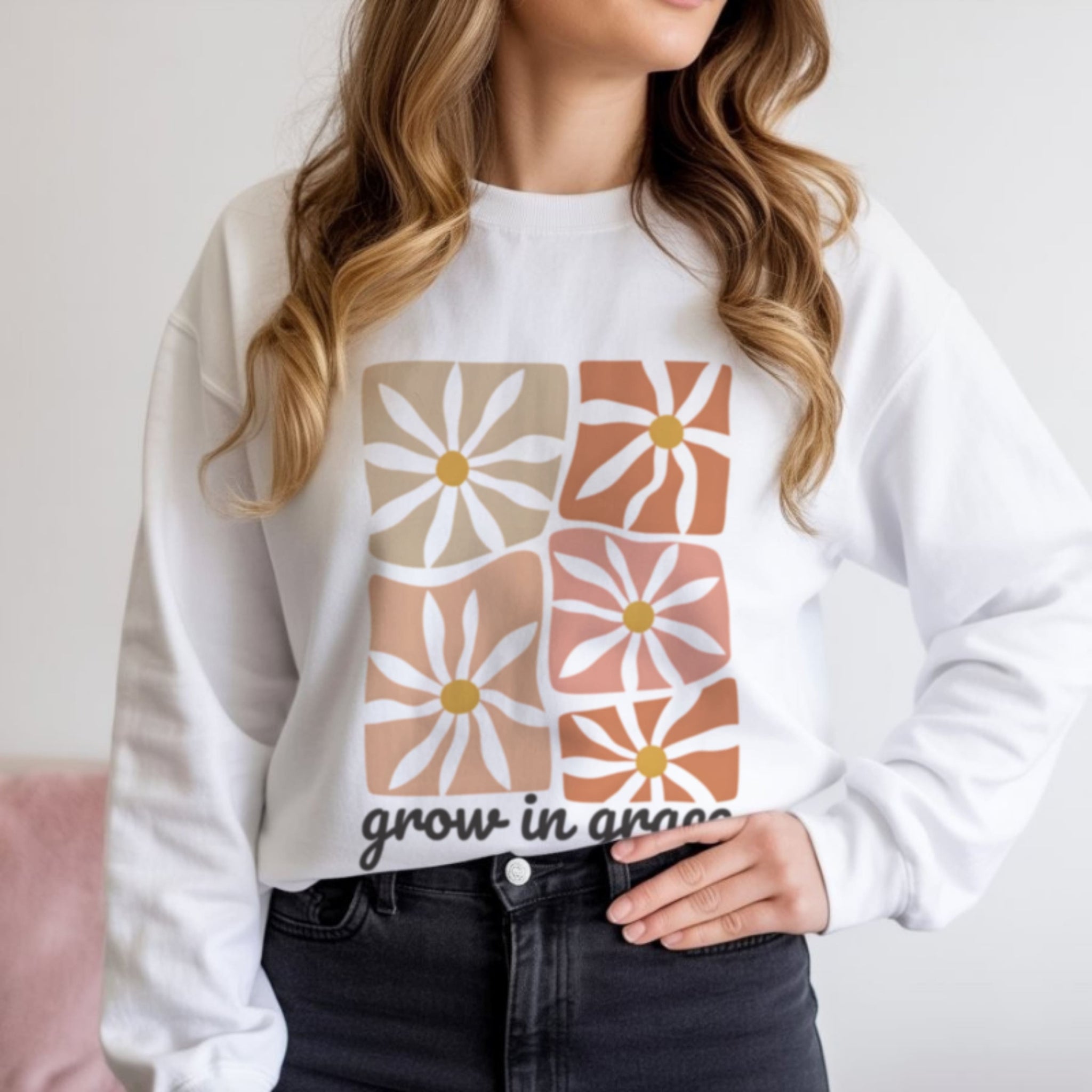 retro daisy block print in earthy tones with Grow In Grace script text, 70s boho aesthetic faith sweatshirt in white