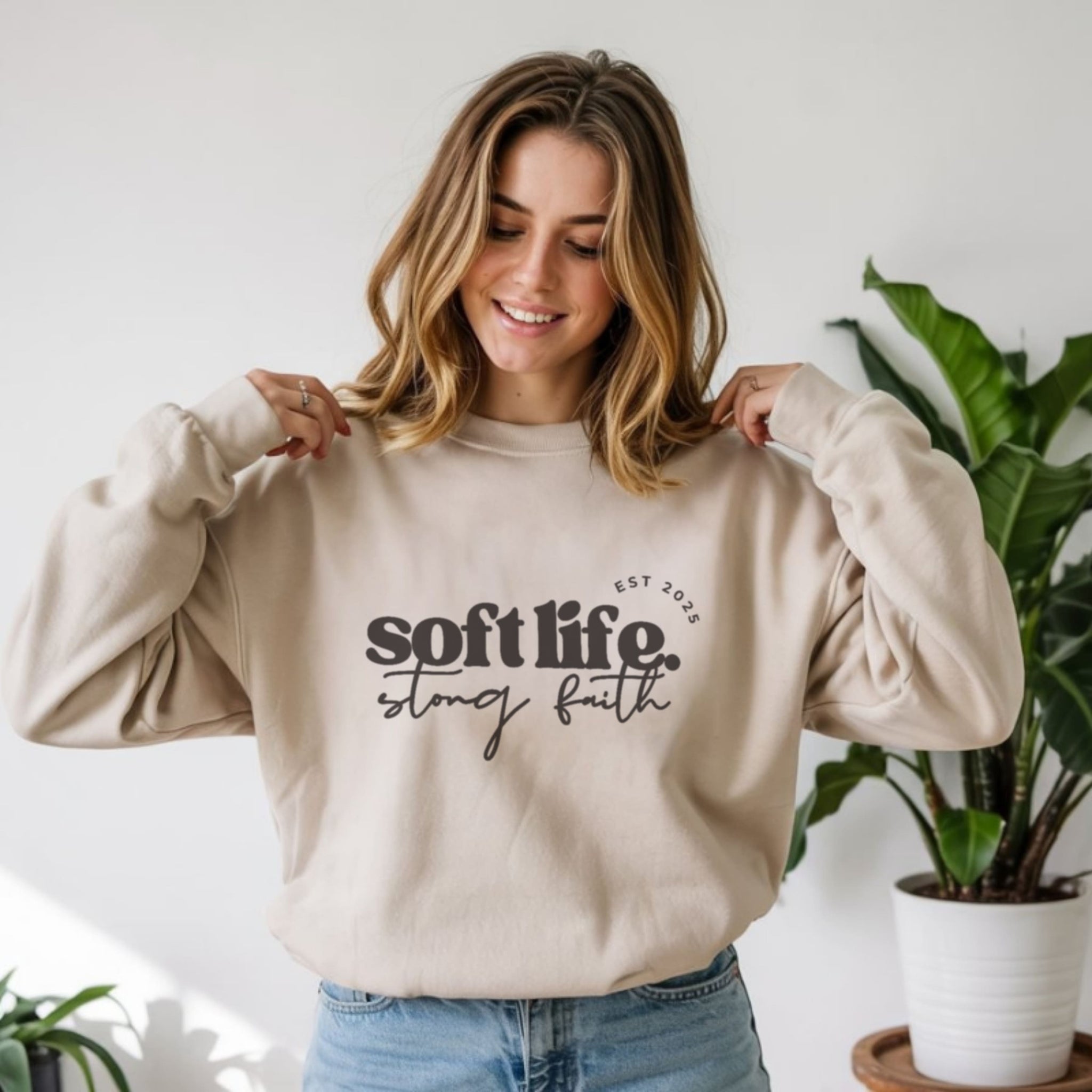 Woman wearing soft life strong faith beige crewneck sweatshirt, cozy minimalist Christian slow living fashion