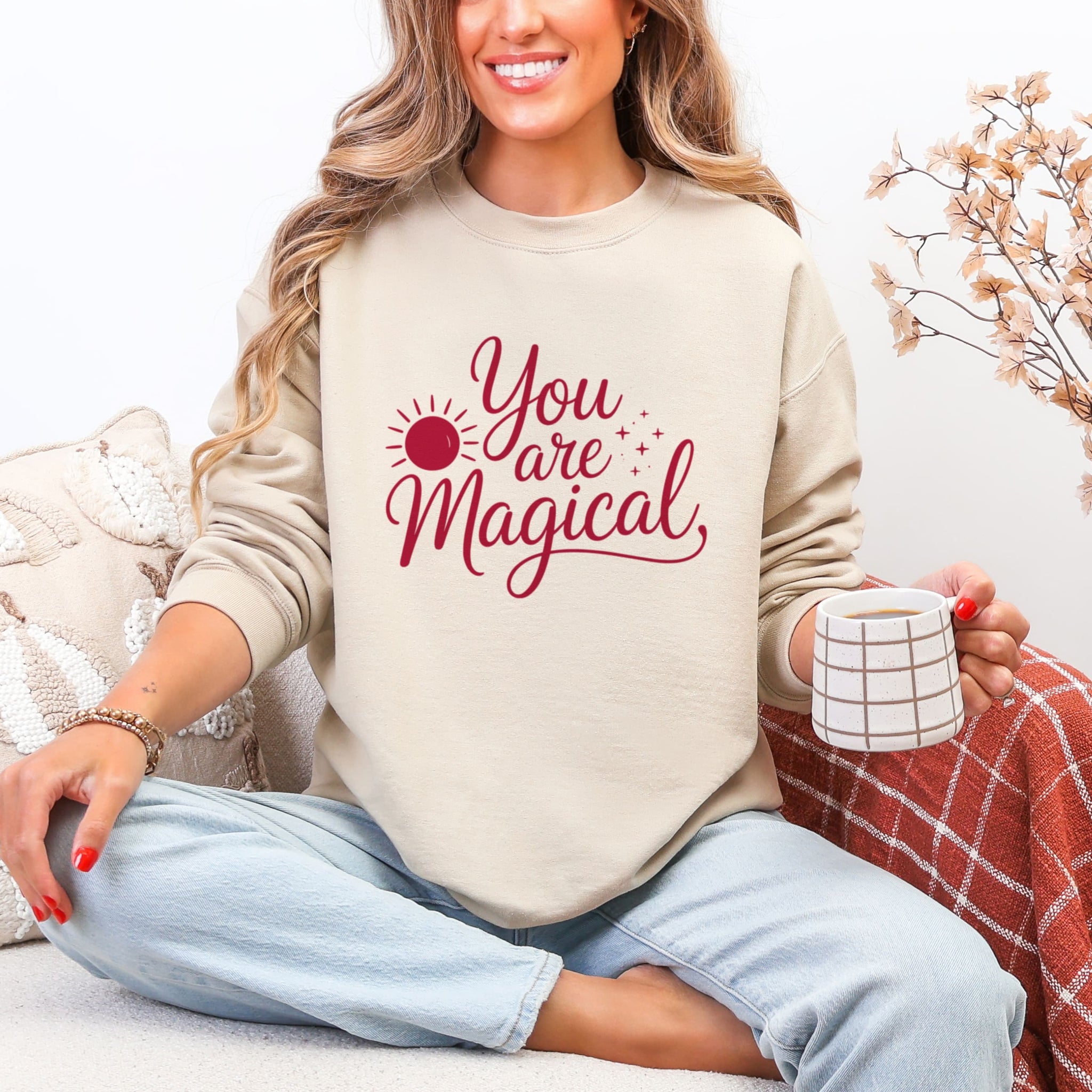 Woman wearing cream You Are Magical sweatshirt with burgundy lettering - inspirational positive affirmation crewneck for women